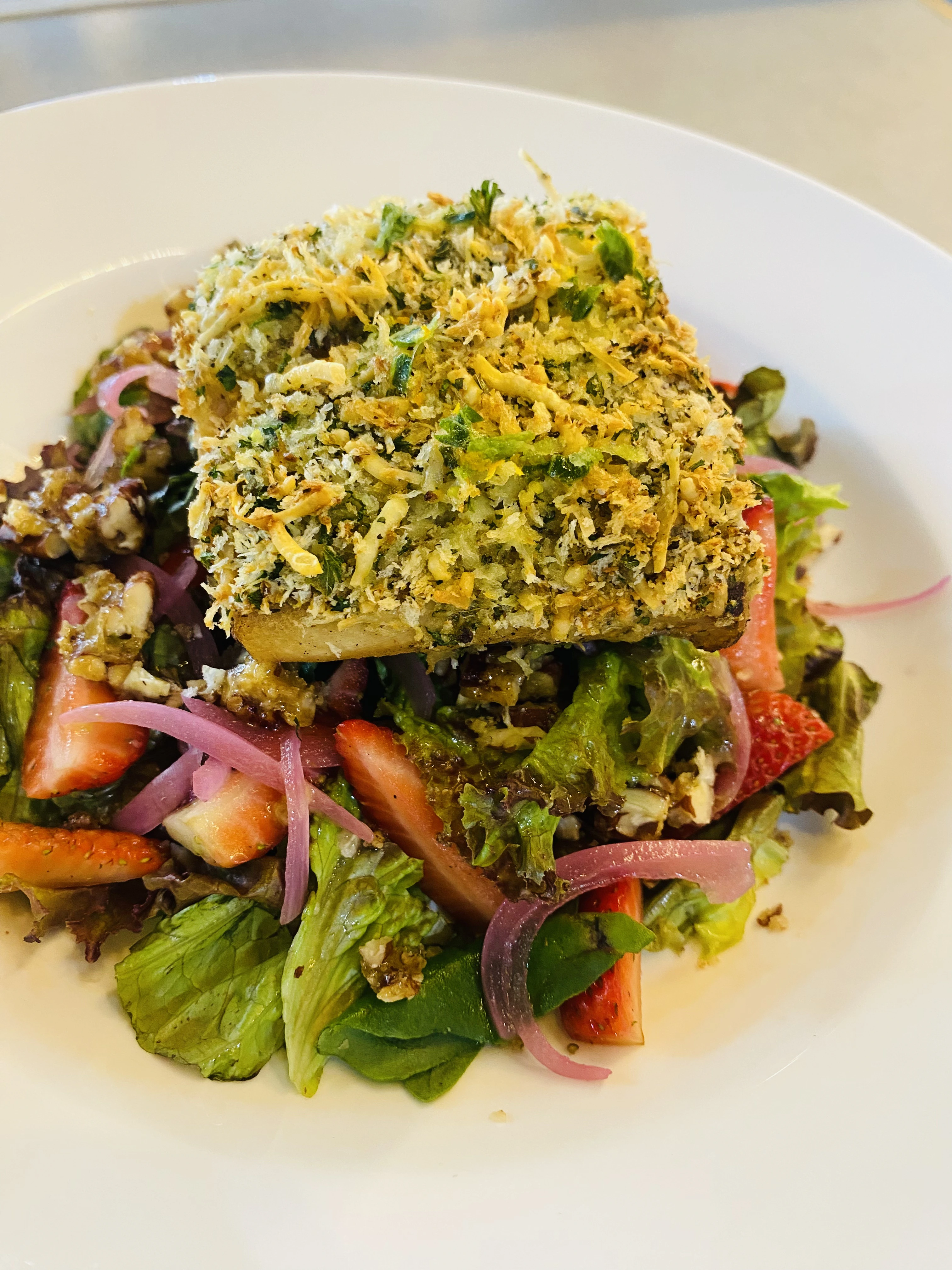 Fish over green salad at Zona K Atelier, restaurant in Jaco, Costa Rica